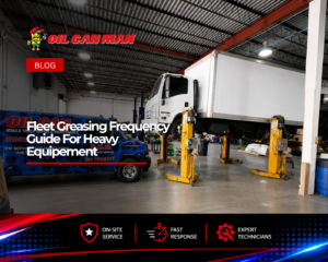 Commercial truck maintenance facility featuring a box truck elevated on hydraulic lifts and a branded mobile repair van parked nearby, showcasing professional fleet service operations inside a spacious industrial workshop.